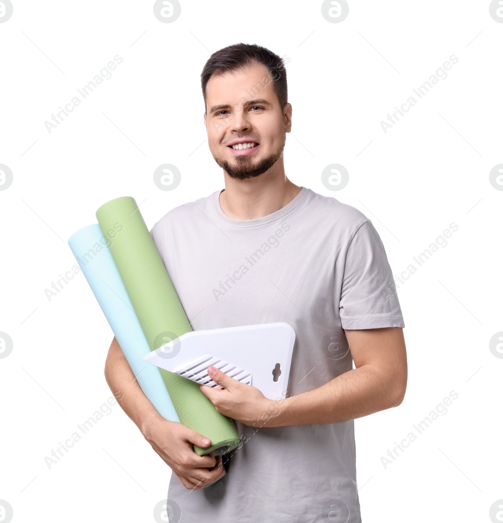 Photo of Man with wallpaper rolls and spatula on white background