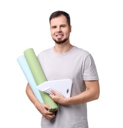 Photo of Man with wallpaper rolls and spatula on white background