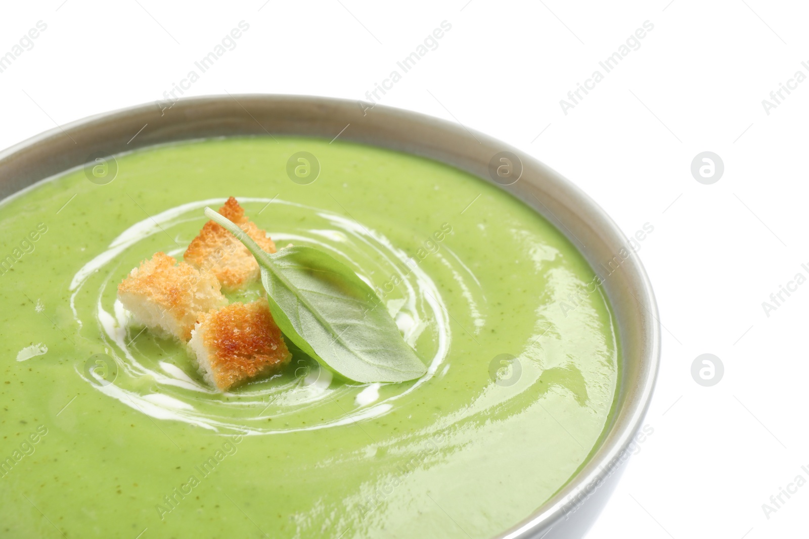 Photo of Tasty homemade zucchini cream soup isolated on white, closeup