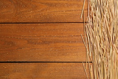 Photo of Dried hay on wooden background, flat lay. Space for text