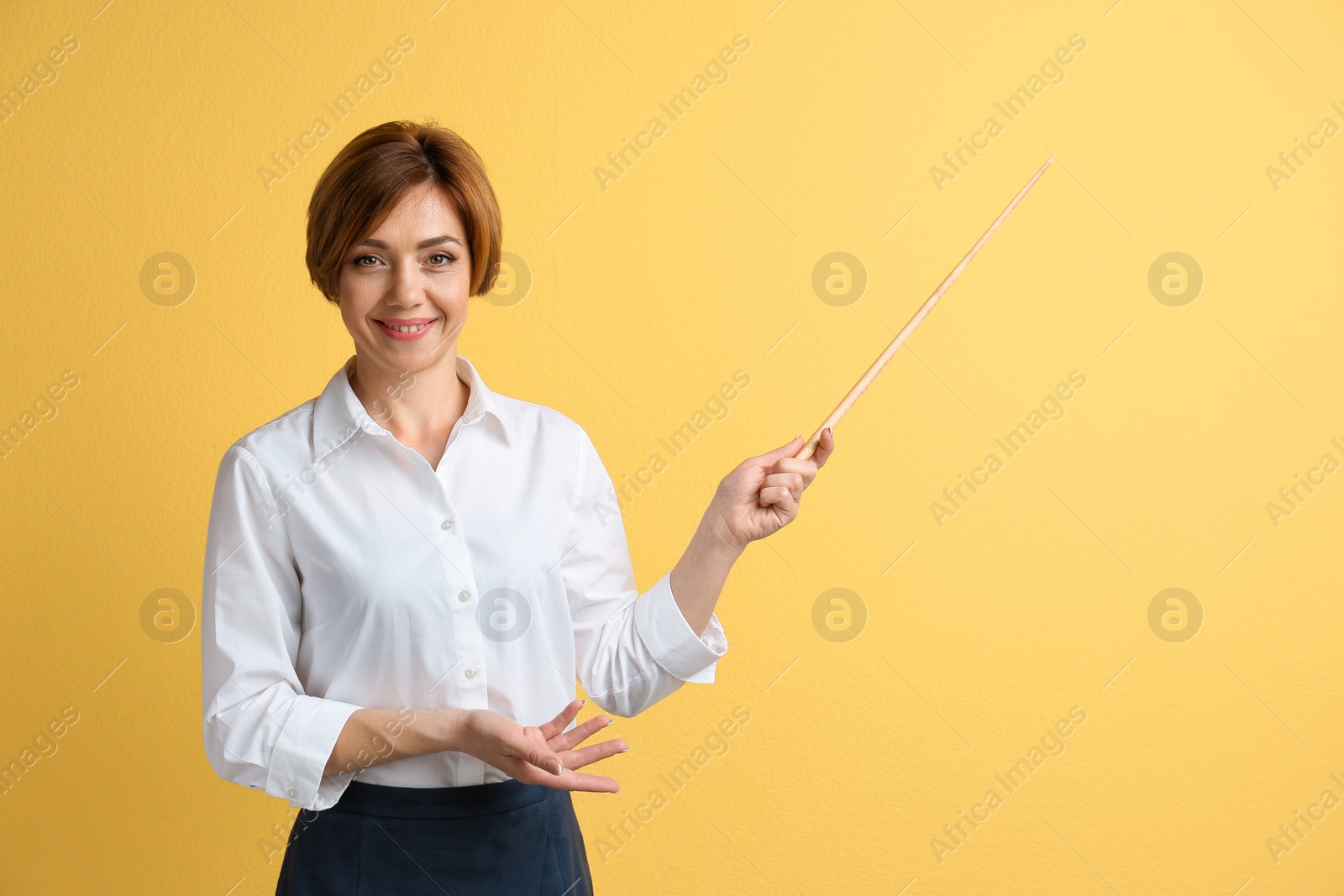 Photo of Portrait of female teacher with pointer on color background