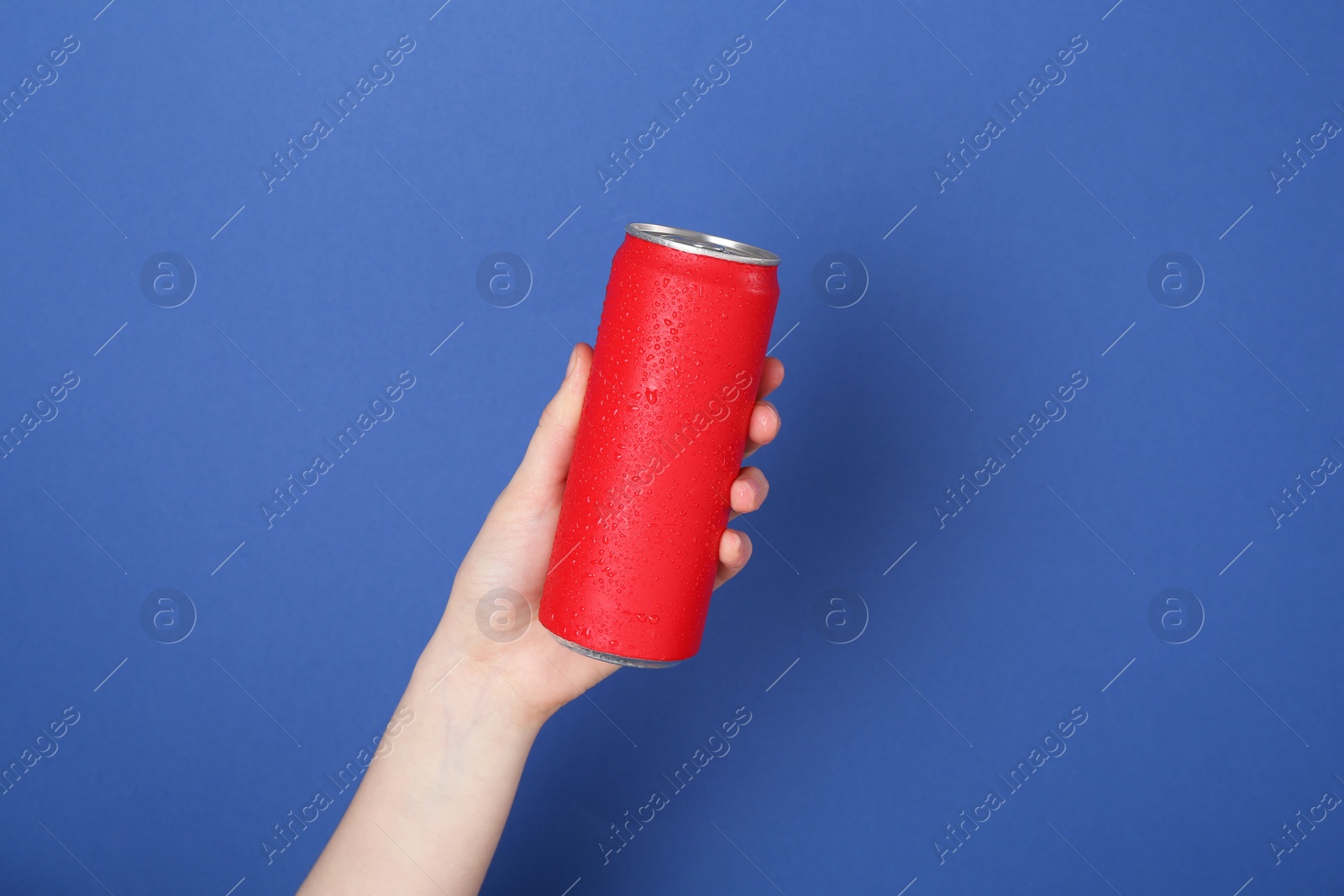 Photo of Woman with energy drink on blue background, closeup