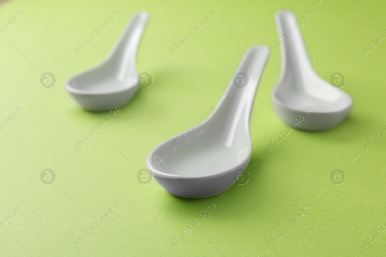 Photo of Clean Miso soup spoons on green background