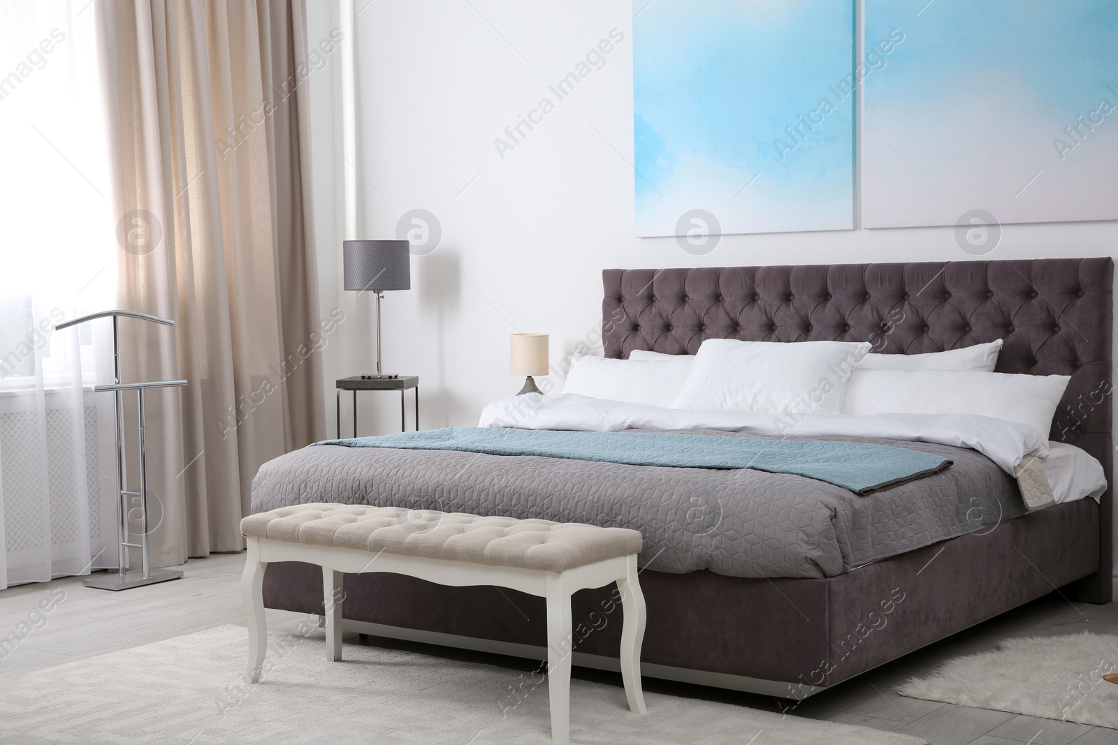 Photo of Stylish room interior with large comfortable bed