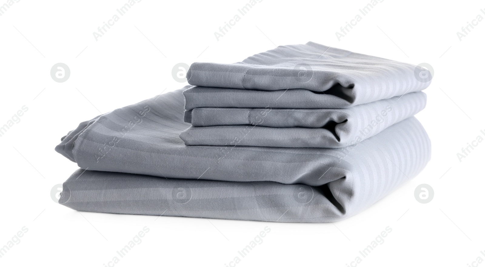 Photo of Stack of clean bed sheets isolated on white