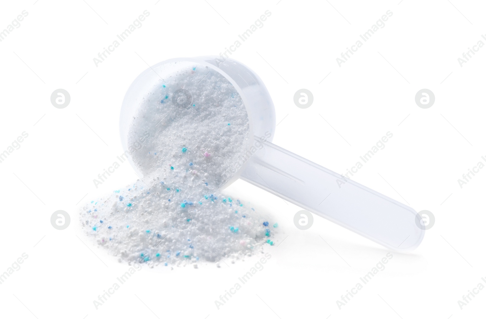 Photo of Measuring spoon and scattered laundry detergent on white background