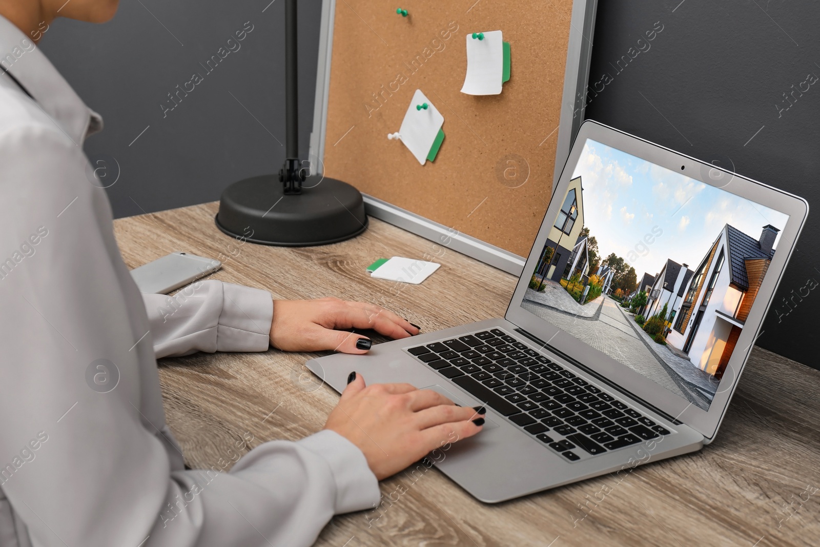 Image of Businesswoman or real estate agent looking through online property portfolio, closeup