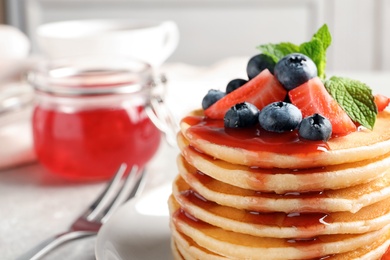 Photo of Plate with pancakes and berries on table, closeup