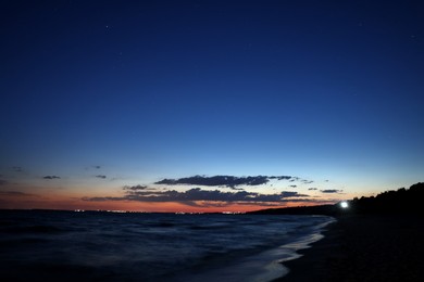 Photo of Picturesque view of beautiful sunset on seaside at night