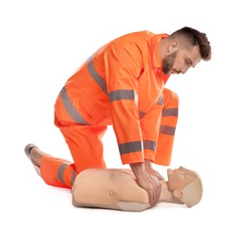 Photo of Paramedic in uniform practicing first aid on mannequin against white background