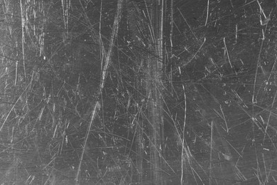 Photo of Texture of scratched metallic surface as background, closeup