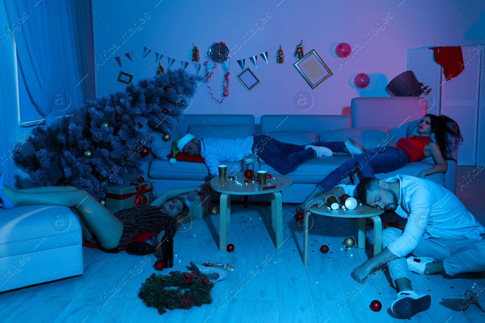 Photo of Drunk friends sleeping in messy room after New Year party