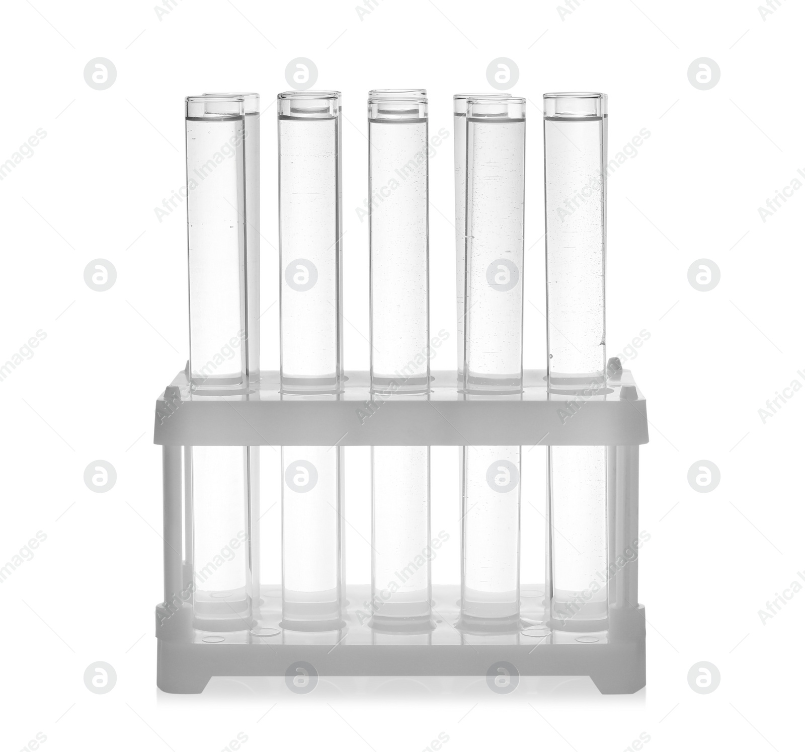 Photo of Test tubes with transparent liquid in holder isolated on white