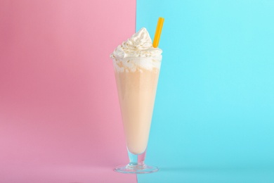 Photo of Glass with delicious milk shake on color background