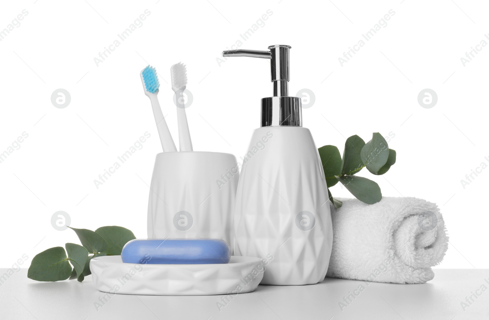Photo of Bath accessories. Different personal care products and eucalyptus branches on table against white background