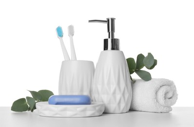 Photo of Bath accessories. Different personal care products and eucalyptus branches on table against white background