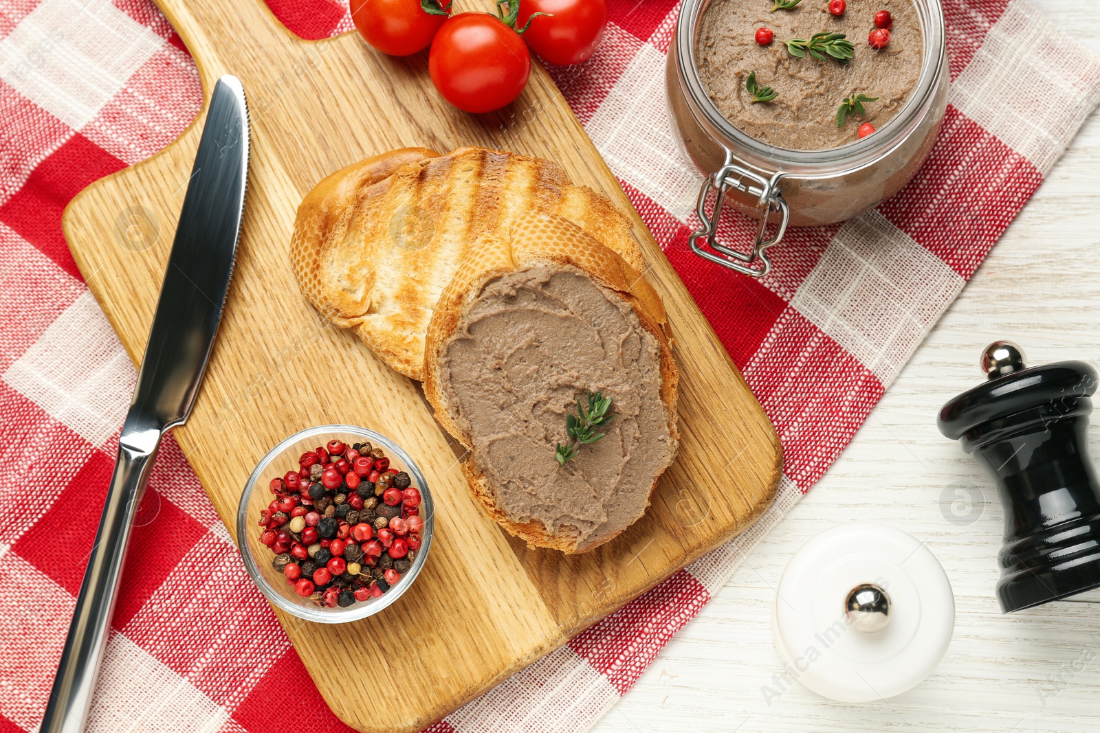 Photo of Fresh bread with delicious liver pate on white wooden table, flat lay