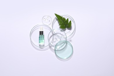 Organic cosmetic product, natural ingredient and laboratory glassware on white background, top view