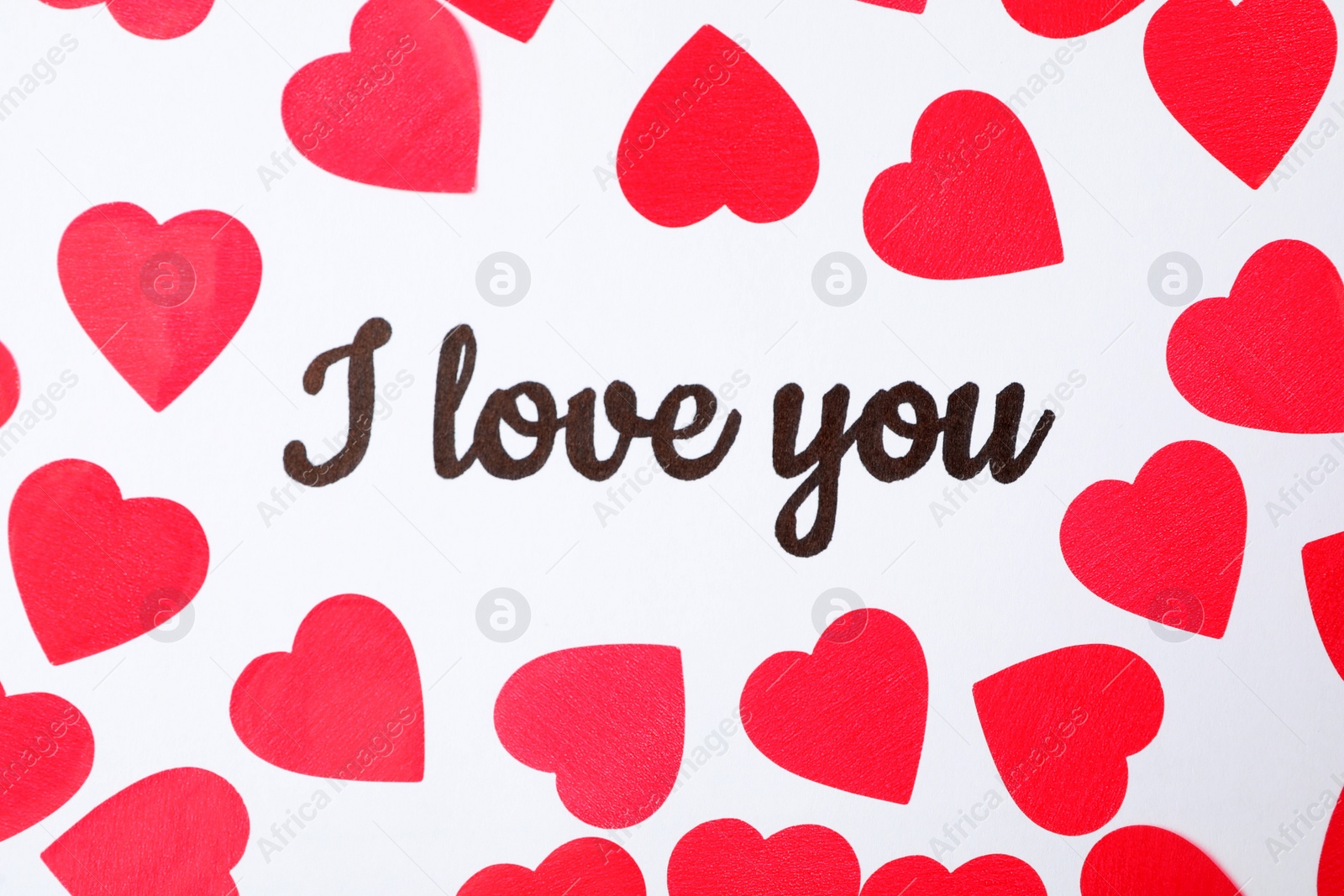 Photo of Text I Love You and red hearts on white background