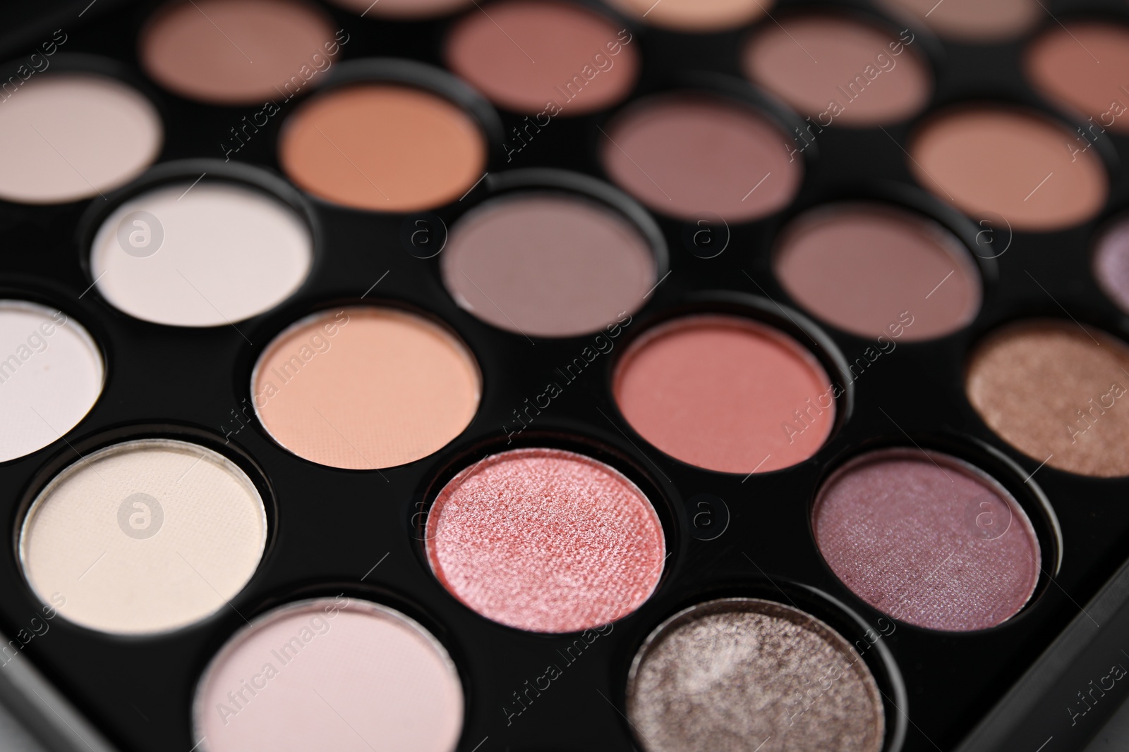 Photo of Beautiful eyeshadow palette as background, closeup. Professional cosmetic product