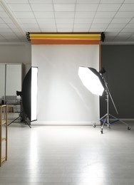 Photo of White photo background and professional lighting equipment in studio