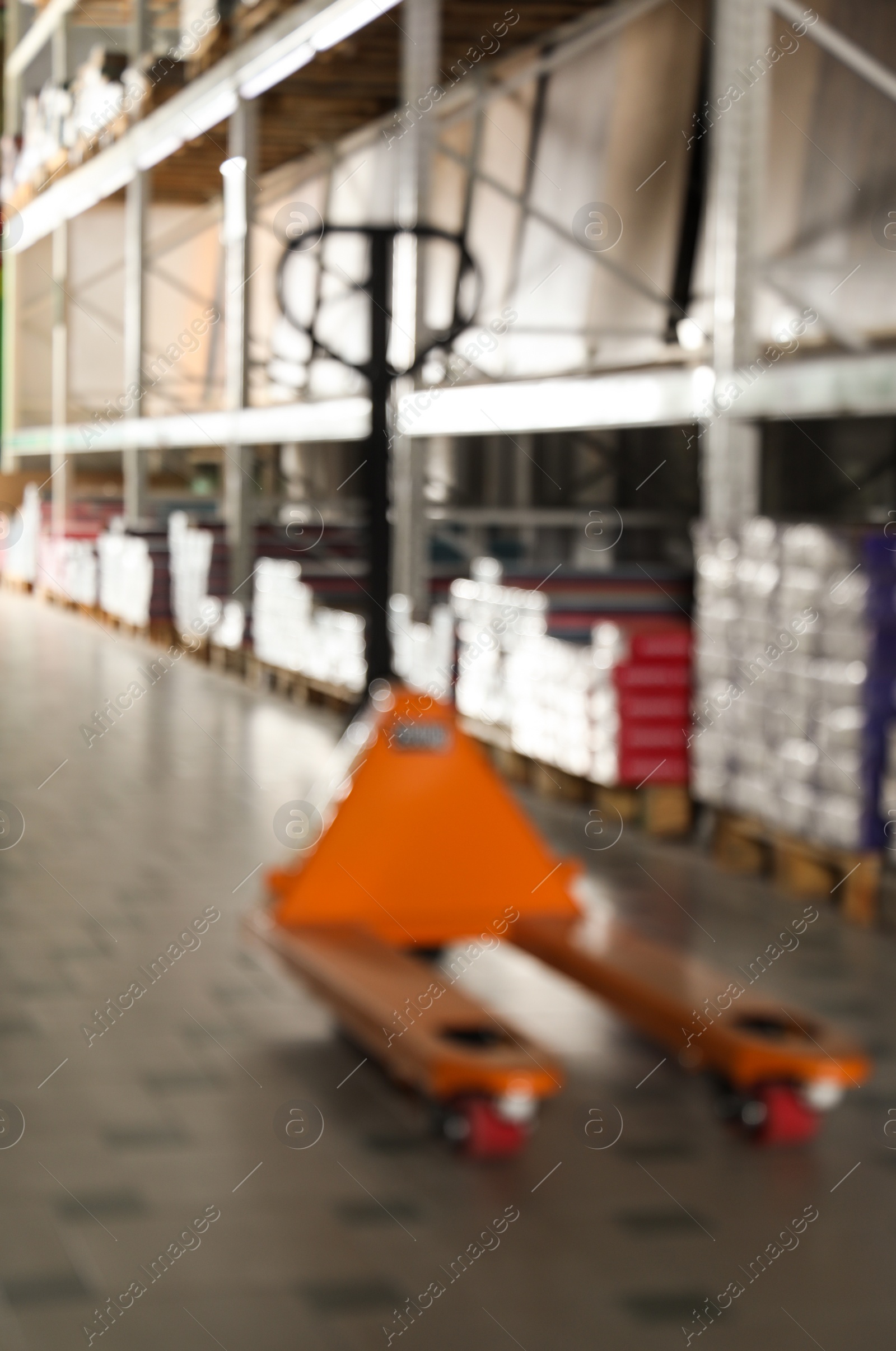 Photo of Blurred view of manual pallet truck in wholesale warehouse