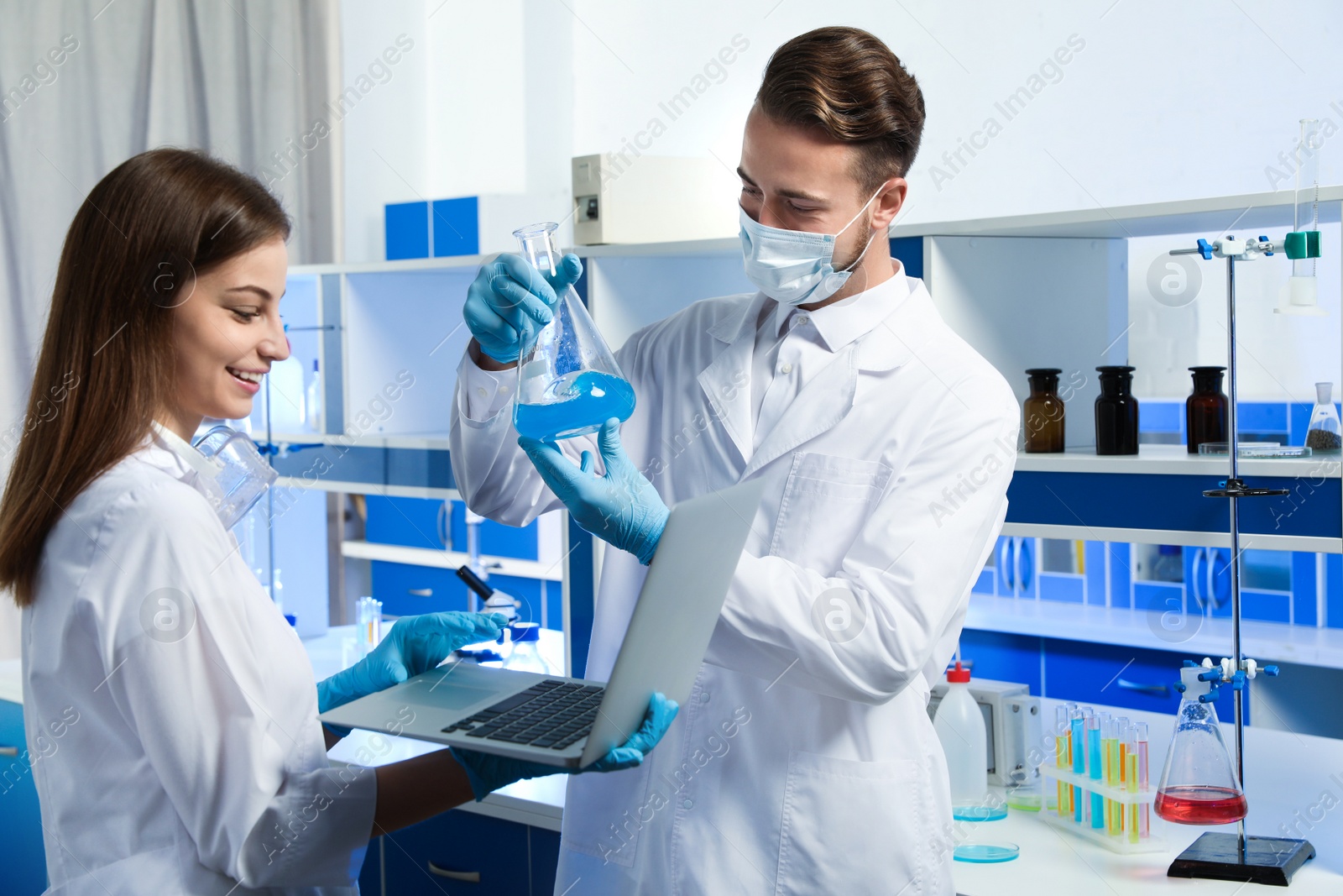 Photo of Young scientists doing research and analysis in chemical laboratory