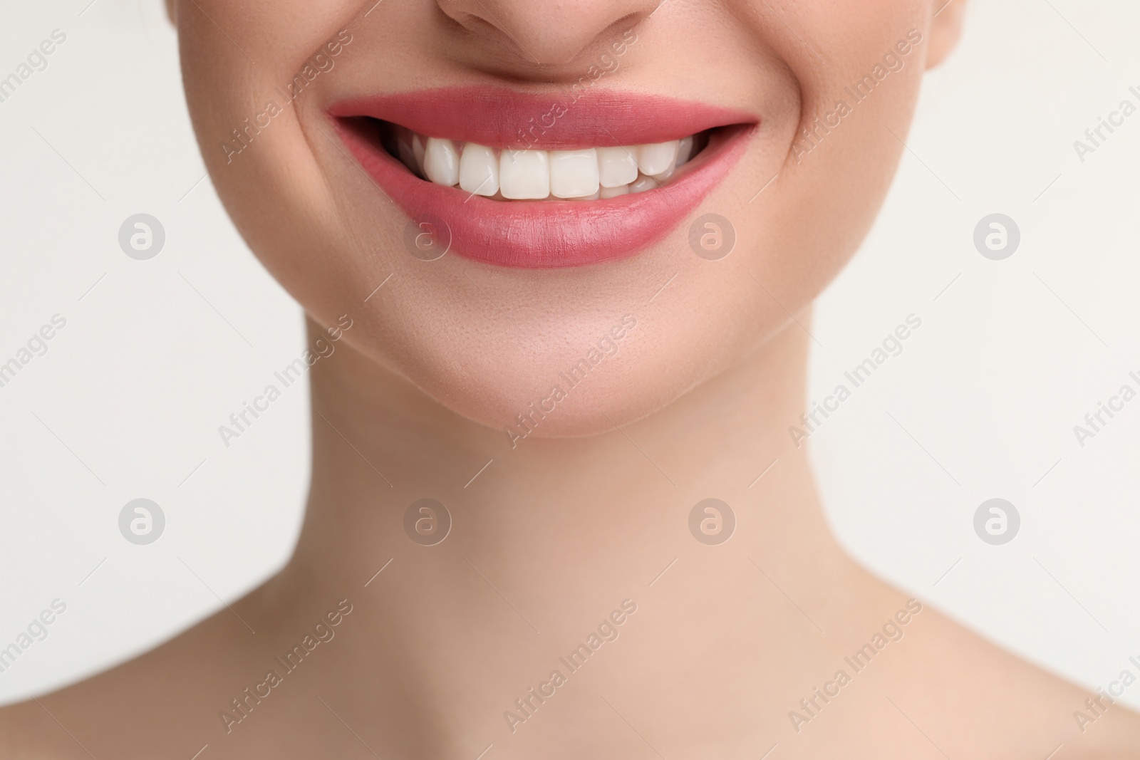 Photo of Young woman with beautiful smile on white background, closeup