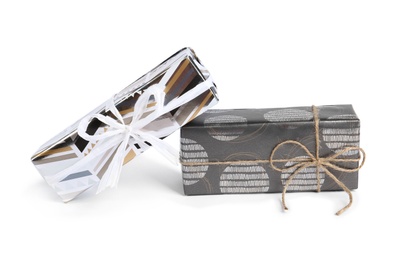 Photo of Beautiful gift boxes with bows on white background