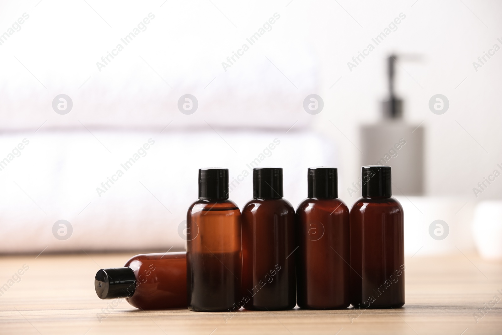 Photo of Mini bottles with cosmetic products on table. Hotel amenities