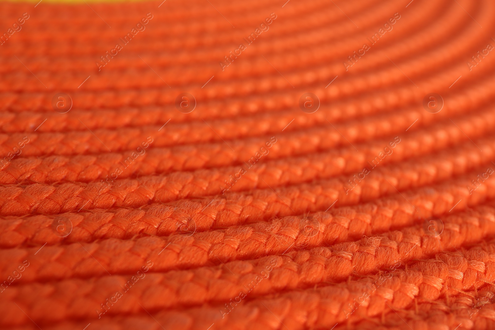 Photo of Texture of orange wicker mat as background, closeup view