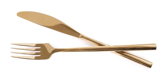 Photo of New shiny golden fork and knife on white background, top view