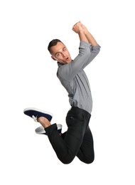 Photo of Young man in casual clothes jumping on white background