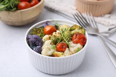 Photo of Delicious salad with cauliflower and tomato served on white table, closeup