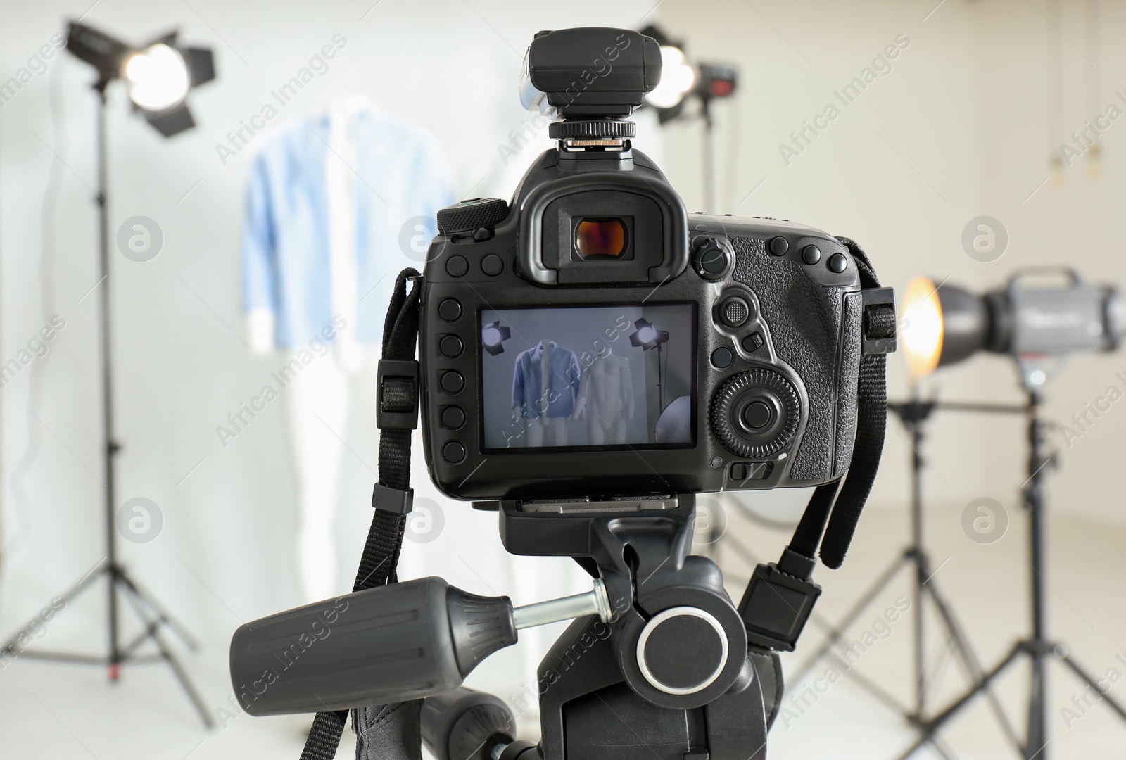 Photo of Taking pictures of ghost mannequin with modern clothes in professional photo studio, focus on camera