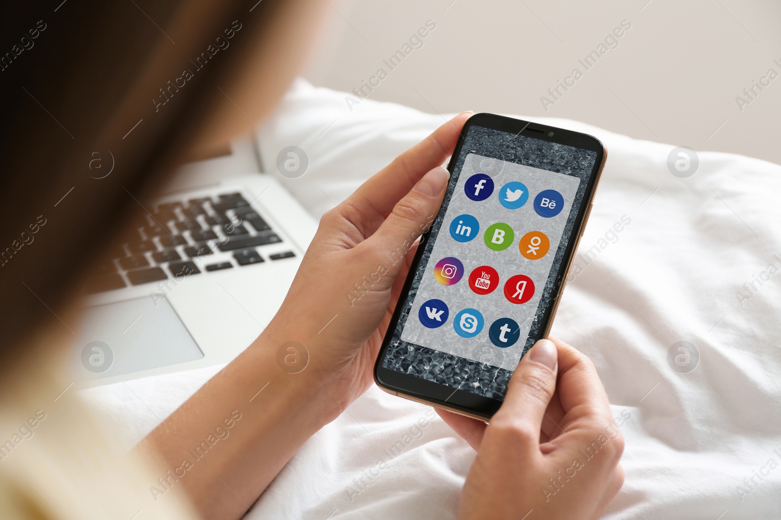 Image of MYKOLAIV, UKRAINE - APRIL 30, 2020: Woman holding phone with social media apps icons on screen indoors, closeup