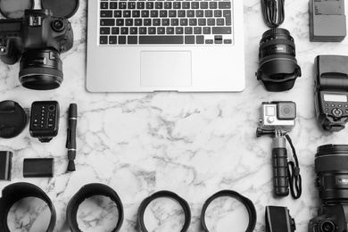 Photo of Flat lay composition with photographer's equipment , laptop and space for text on white marble table