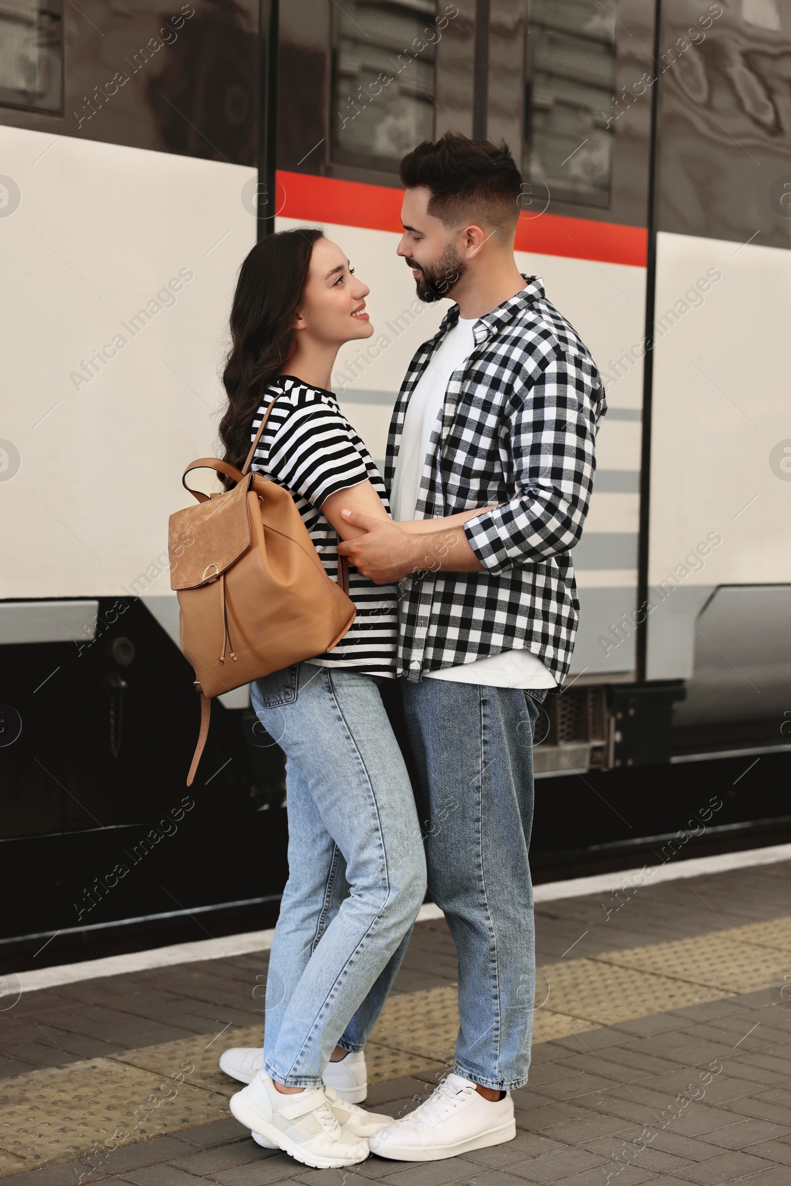 Photo of Long-distance relationship. Beautiful couple on platform of railway station