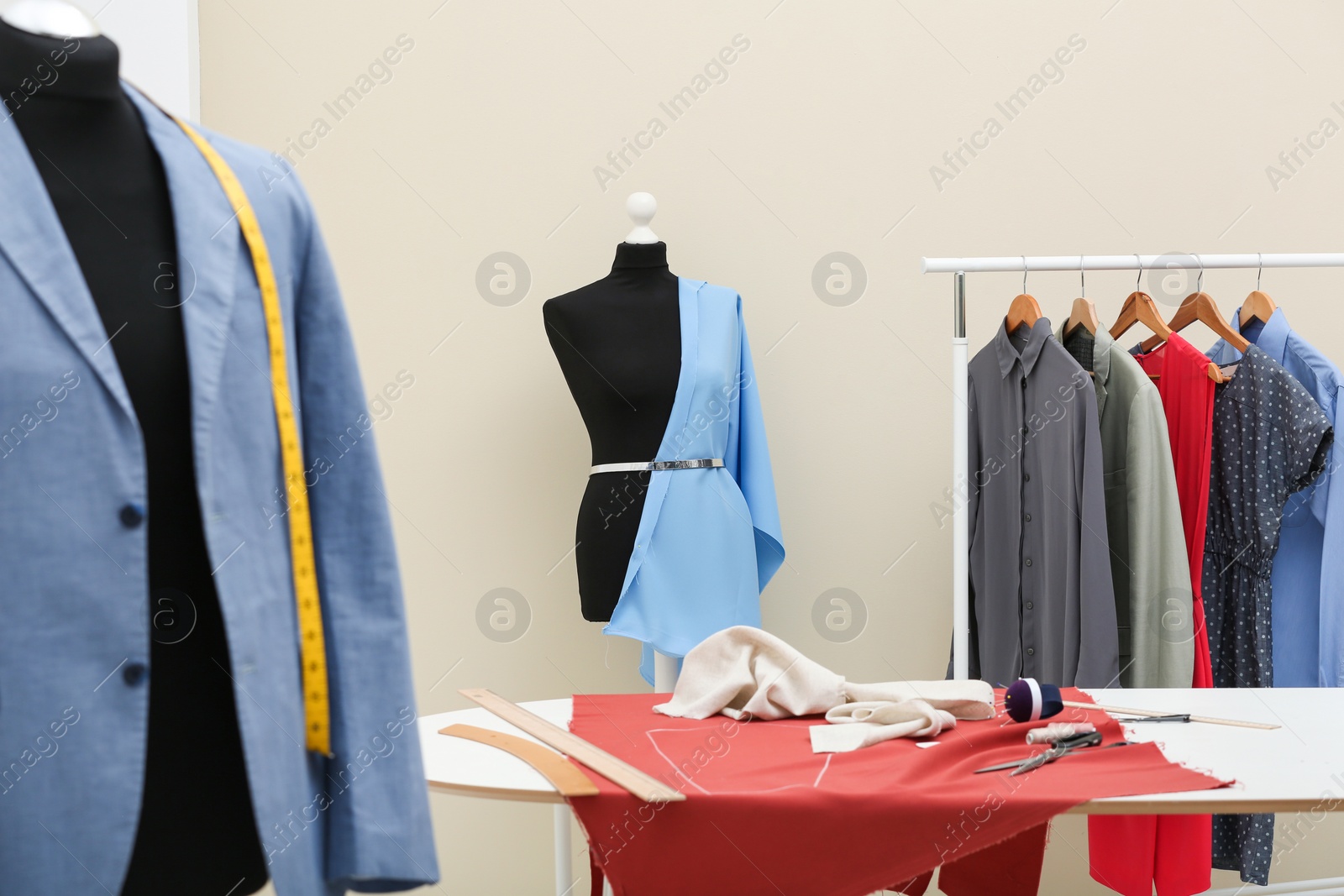 Photo of Mannequin with blue cloth in tailor studio