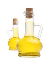 Photo of Glass jugs of cooking oil on white background