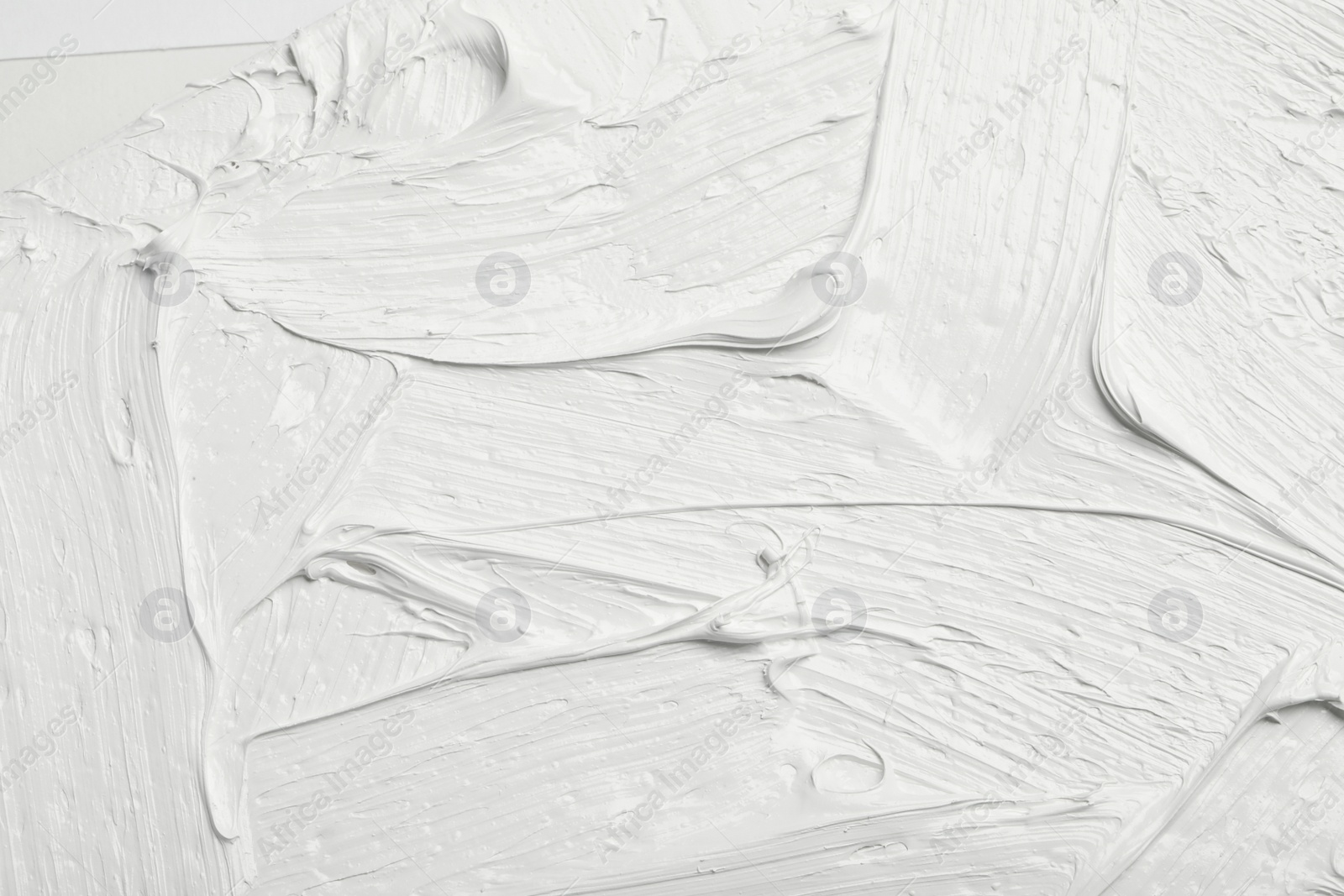 Photo of Texture of white oil paint as background, closeup