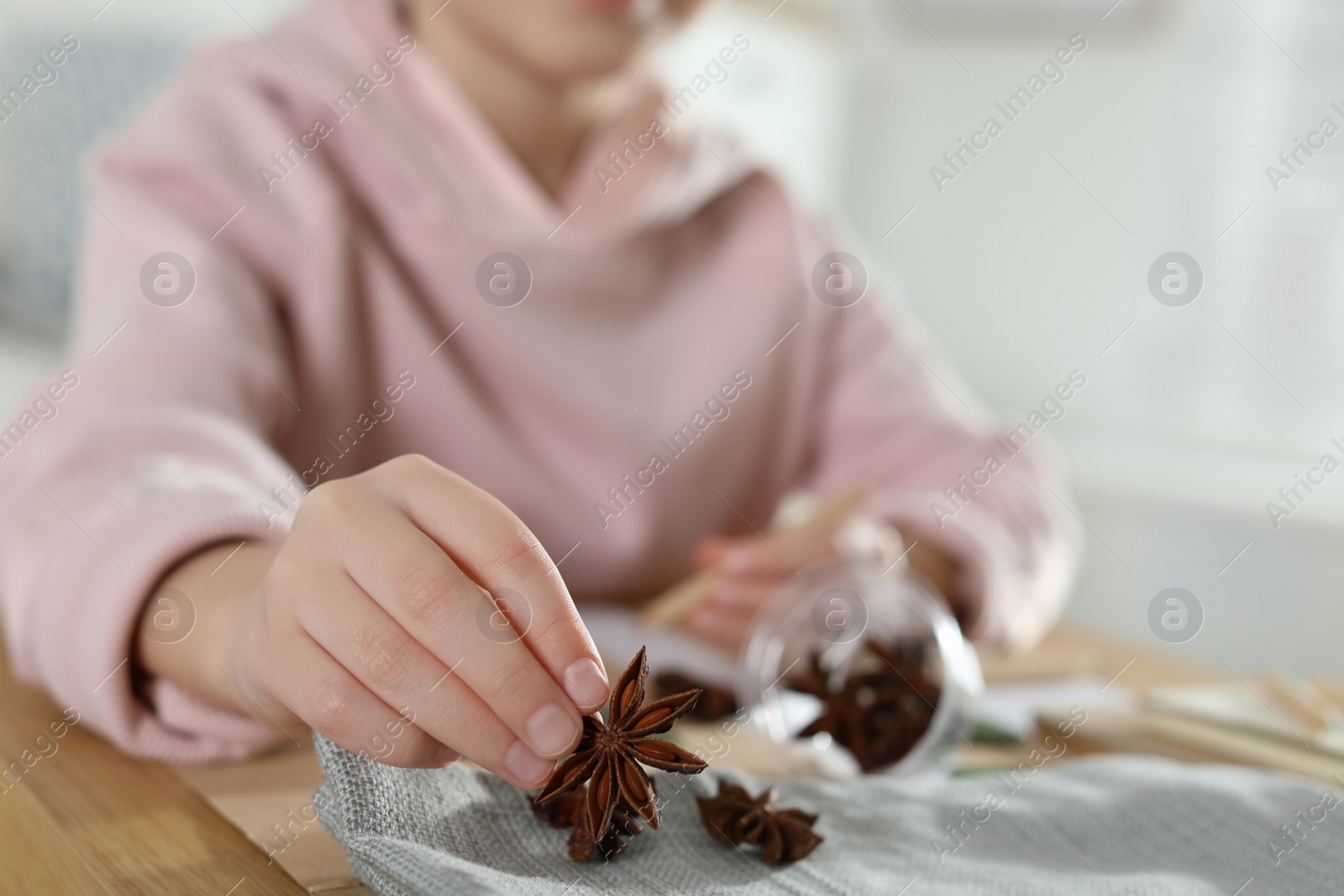 Photo of Little girl working with natural materials at table indoors, closeup. Creative hobby