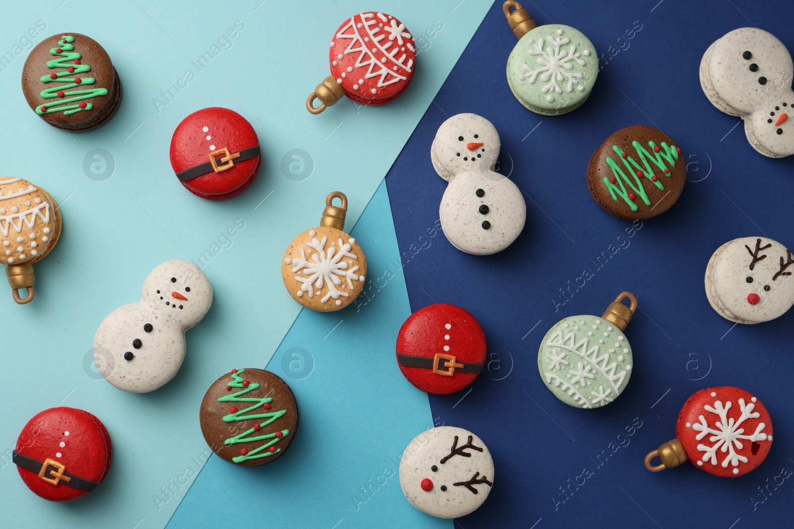 Photo of Beautifully decorated Christmas macarons on color background, flat lay