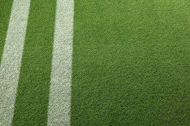 Image of Green grass with white markings, closeup view