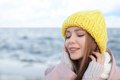 Portrait of beautiful young woman near sea