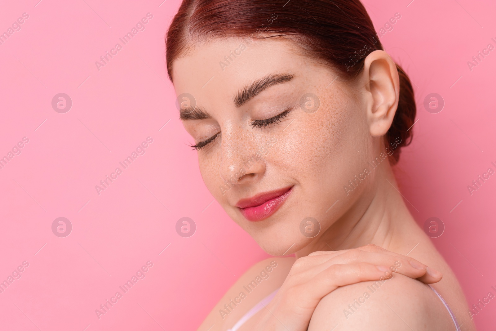 Photo of Portrait of beautiful woman on pink background, closeup. Space for text