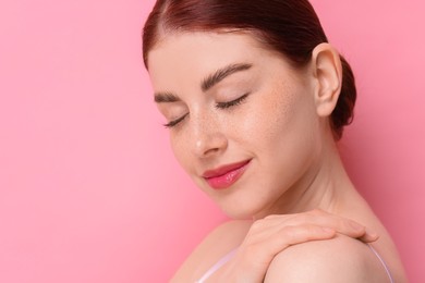 Portrait of beautiful woman on pink background, closeup. Space for text