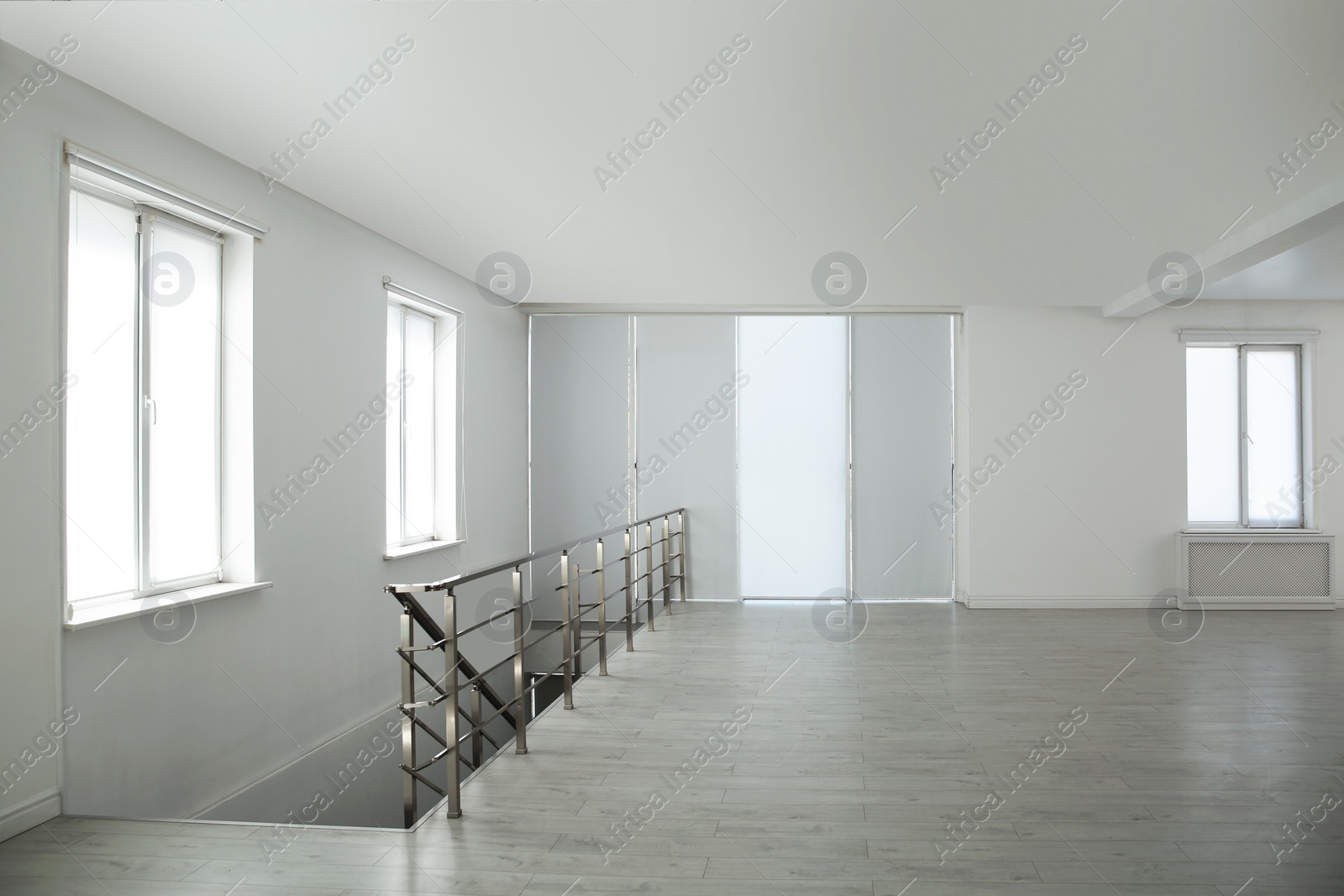 Photo of Large empty hall with windows and railings