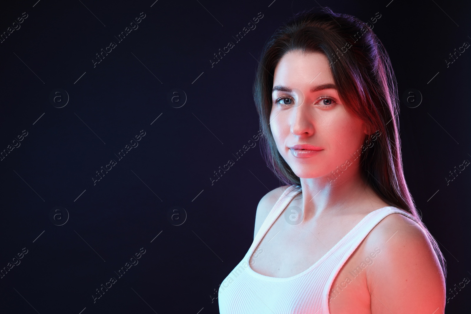 Photo of Portrait of beautiful young woman on color background, space for text