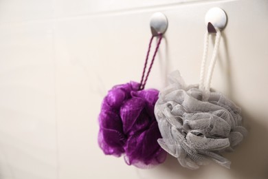 Shower puffs hanging in bathroom, space for text